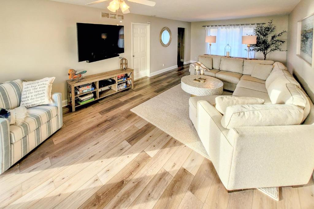a living room with a couch and a tv at Benton Harbor Lake House with Dock and Fire Pit! in Woodland Beach