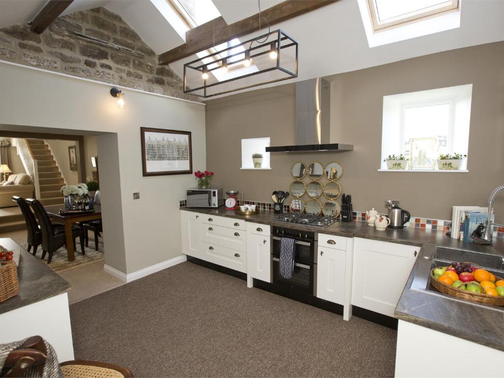 a kitchen with a sink and a stove top oven at 1 Bed in Pateley Bridge G0015 in Pateley Bridge