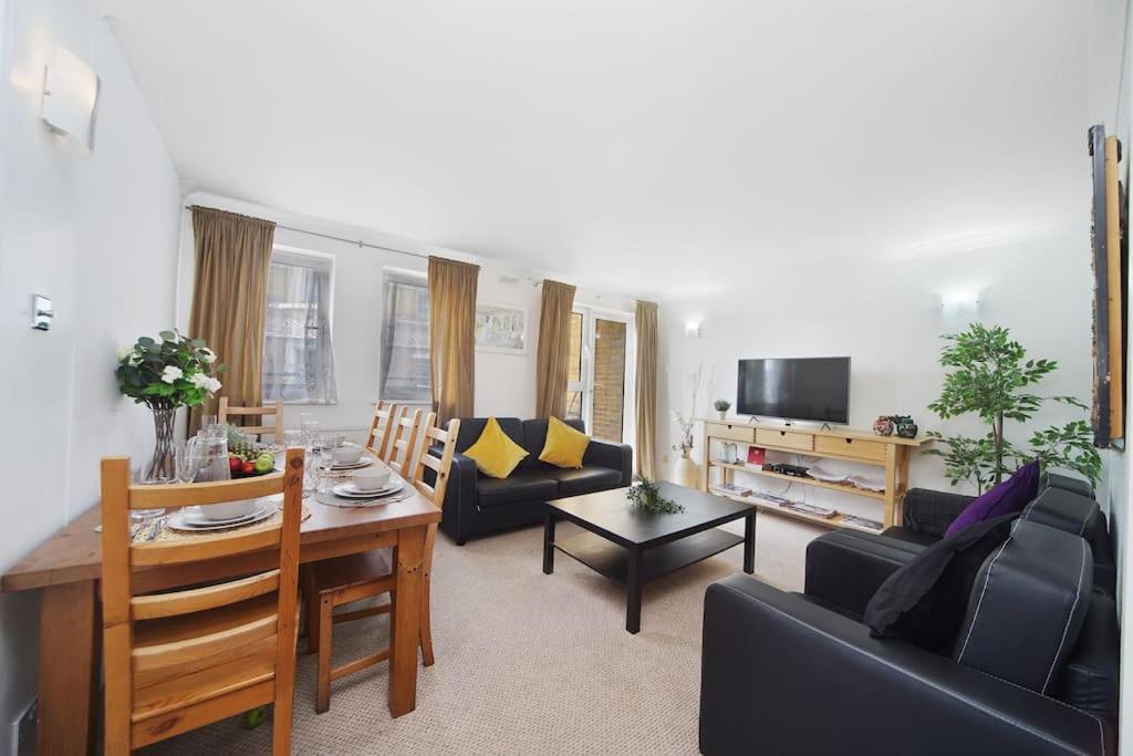 a living room with a couch and a table at Stunning 4-Bed Apartment in London