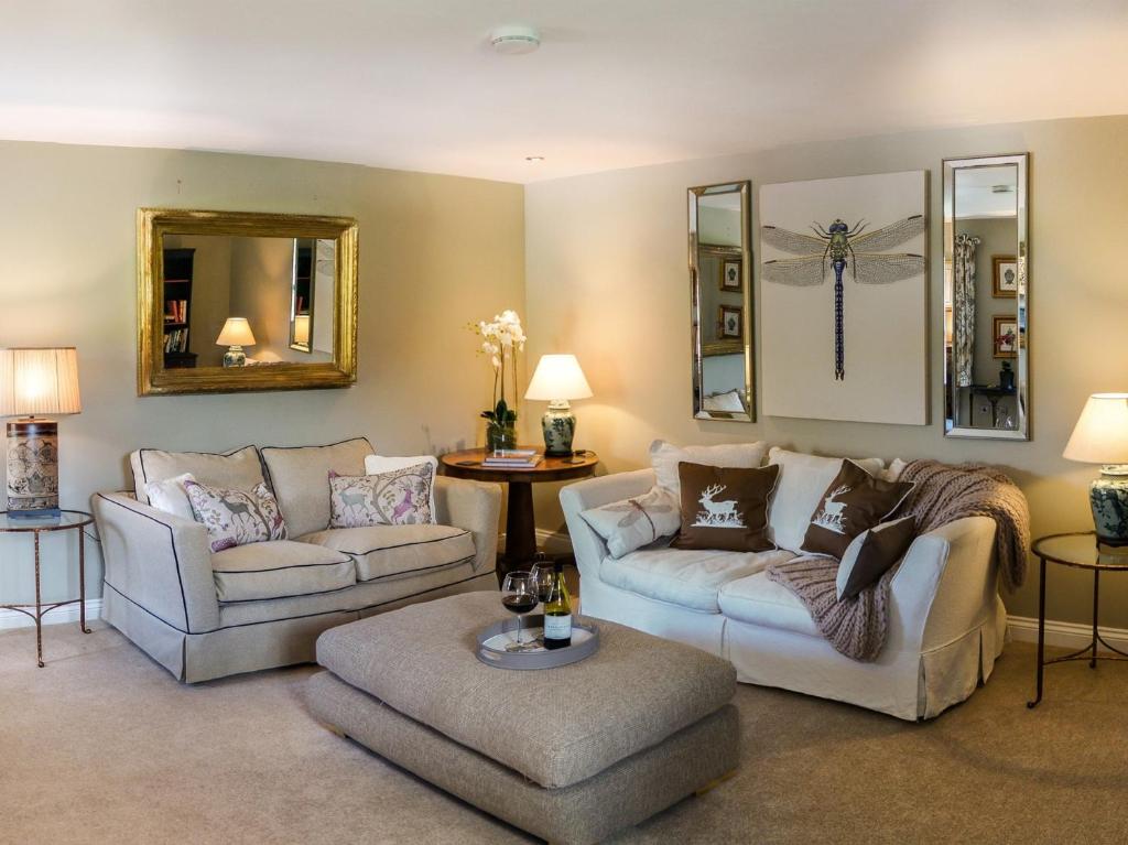 a living room with two couches and a table at 1 Bed in Pateley Bridge G0050 in Pateley Bridge