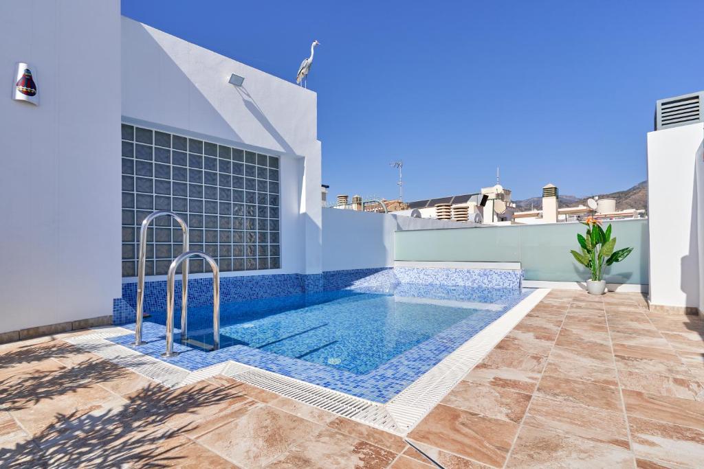 a swimming pool on the side of a house at Nerja Boutique 204 Beauty in Nerja