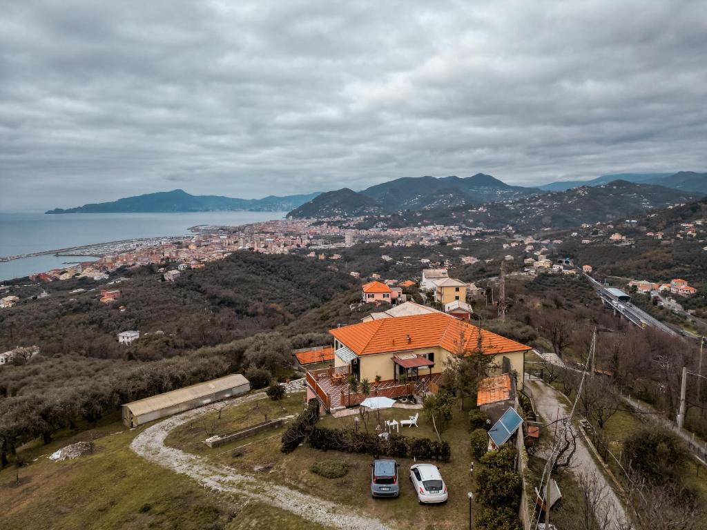 an aerial view of a house with cars on a hill at [5 TERRE]The Terrace on the Gulf - Parking / Wi-fi in Lavagna
