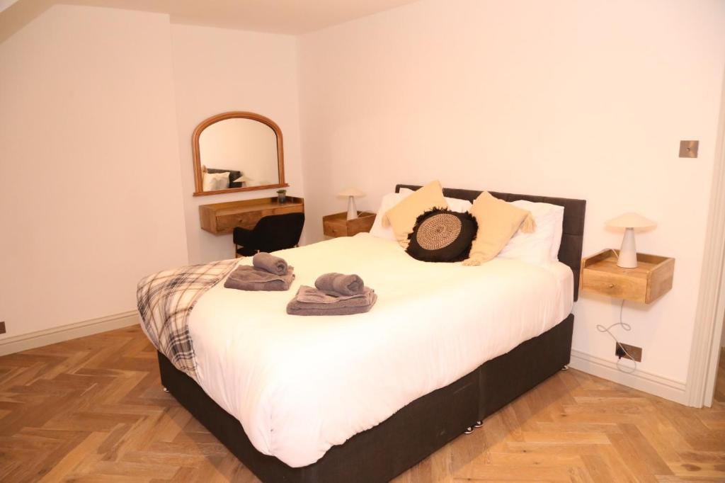 Un dormitorio con una cama con sombreros. en Star London Edgware Road 2-Bed Haven, en Londres