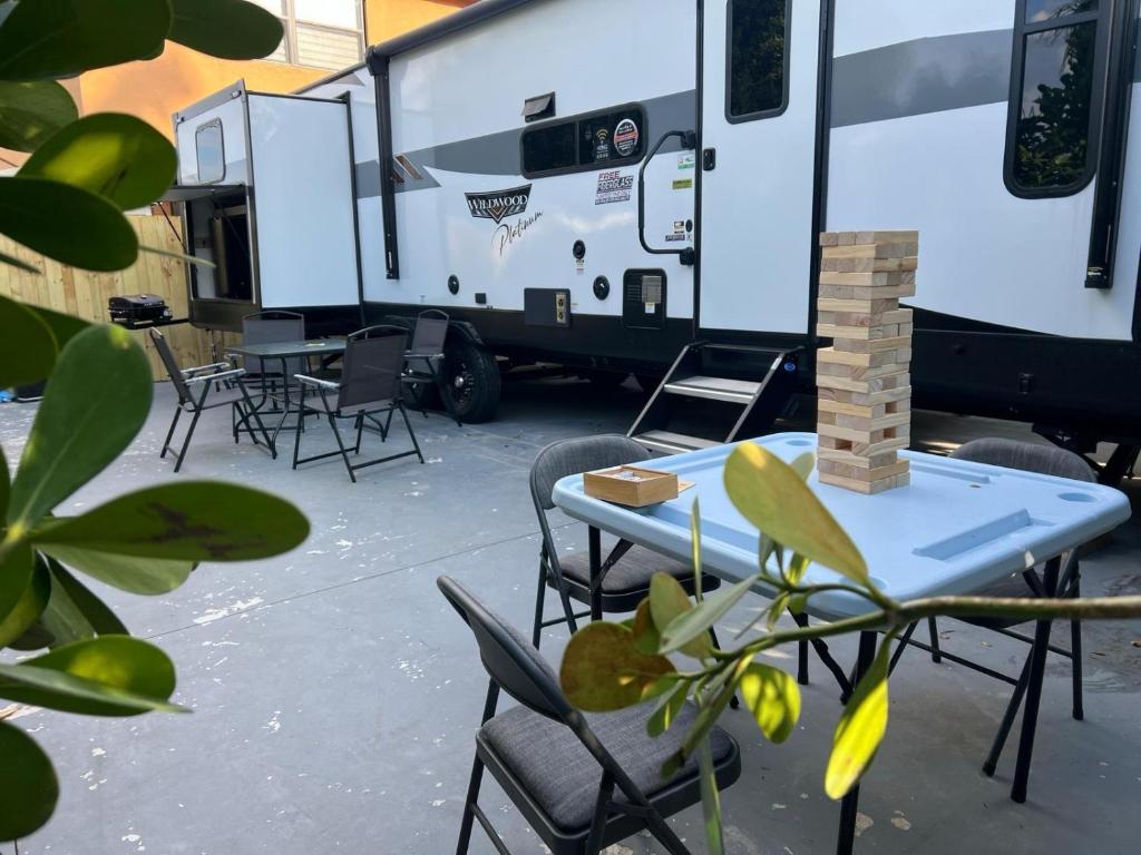 a picnic table and chairs in front of an rv at Homestead RV in Homestead
