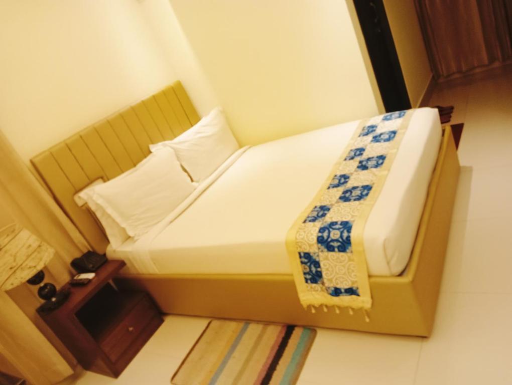 a small bed in a small room with at grand dhaka in Dhaka