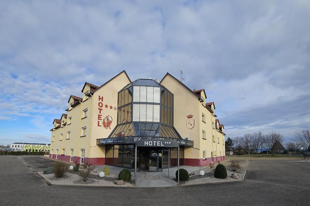 a hotel building with a sign on the front of it at Hotel Restaurant Champ Alsace in Haguenau