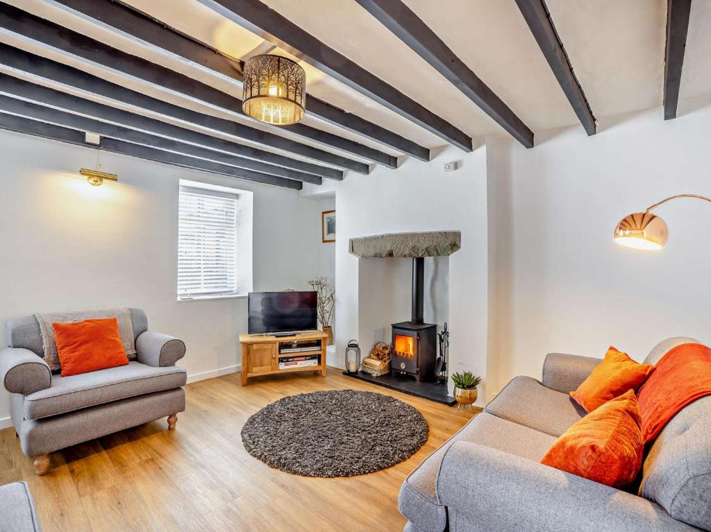 a living room with a couch and a fireplace at 3 Bed in Nefyn 55571 in Nefyn