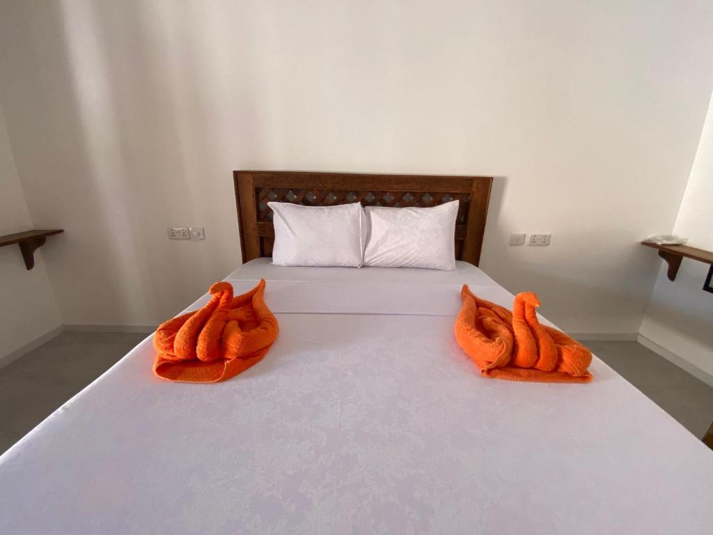 Postel nebo postele na pokoji v ubytování Amani Hotel Paje