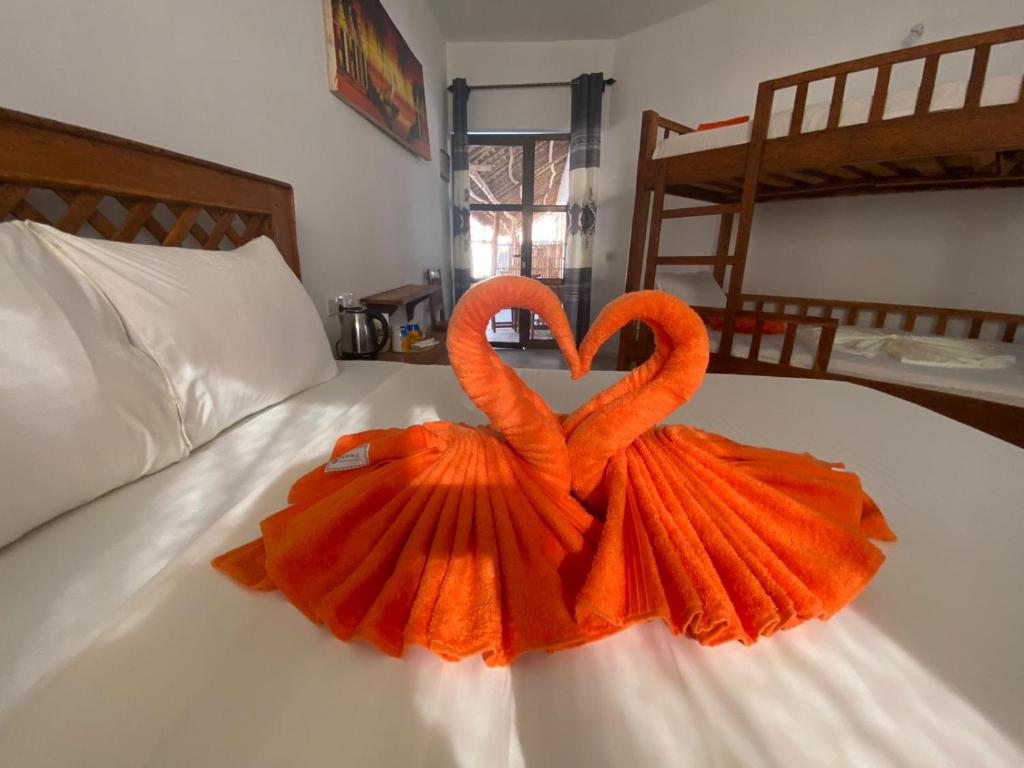 Postel nebo postele na pokoji v ubytování Amani Hotel Paje