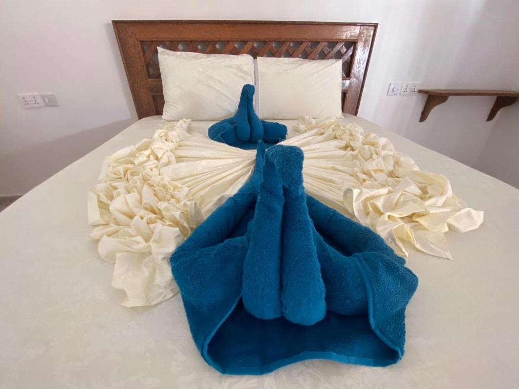 Postel nebo postele na pokoji v ubytování Amani Hotel Paje