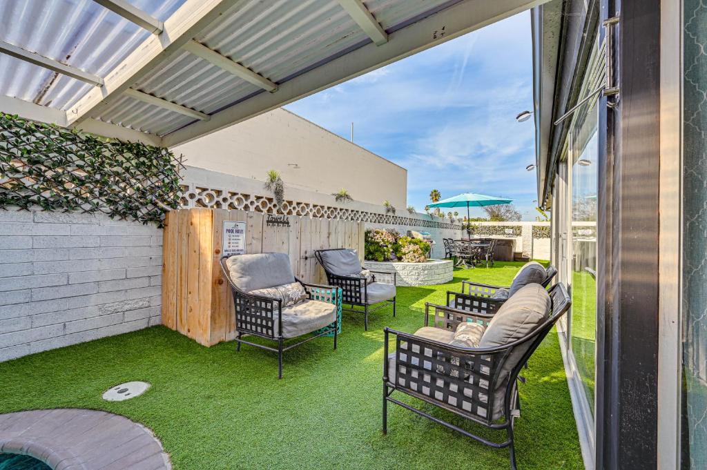 a patio with chairs and tables and a fence at Spacious Chula Vista Home with Heated Pool and Hot Tub in Chula Vista
