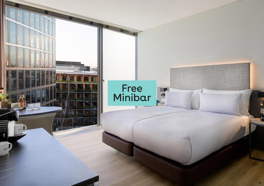 a bedroom with a bed with a free mindset sign on it at INNSiDE by Meliá München Parkstadt Schwabing in Munich