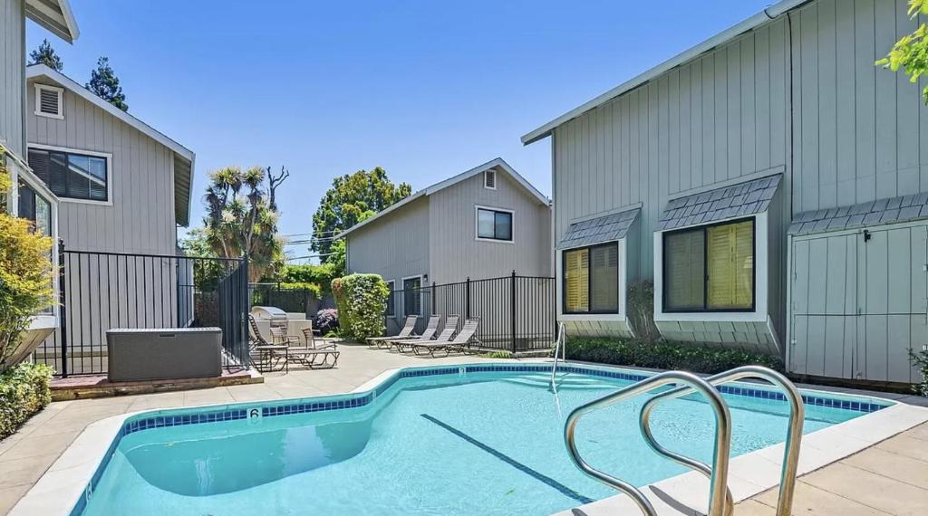 a swimming pool in front of a house at Stanford Housing @ Downtown Palo Alto in Palo Alto