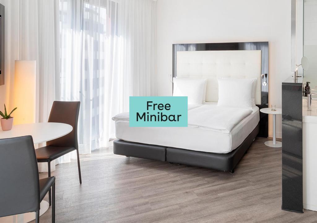 a bedroom with a bed with a free midnight sign on it at INNSiDE by Meliá Frankfurt Ostend in Frankfurt/Main