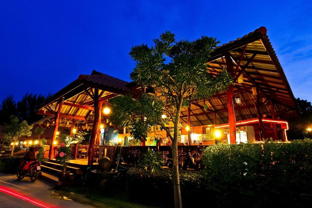 a building with a tree in front of it at night at Ricci House Resort in Ko Lipe