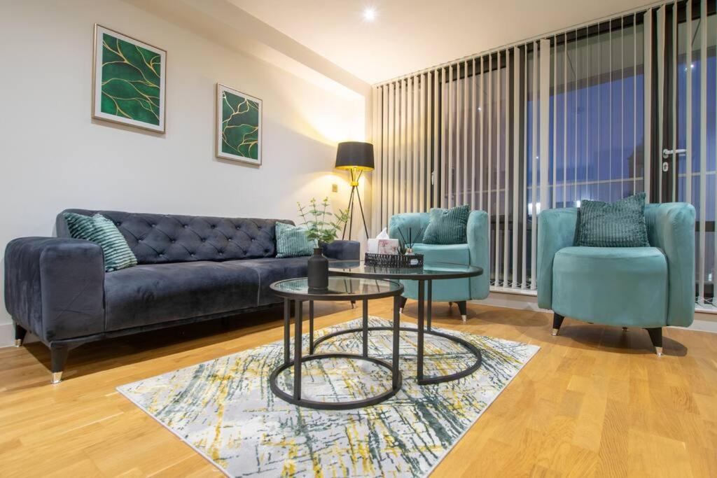 a living room with a couch and two chairs and a table at Luxury City Centre Apartment (Weekly Booking) in Hull