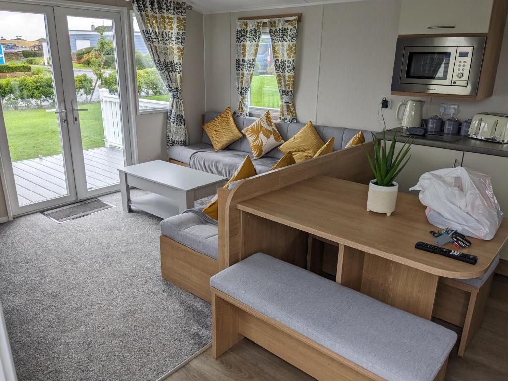 a living room with a couch and a table at R&L'S RETREATS in Cayton