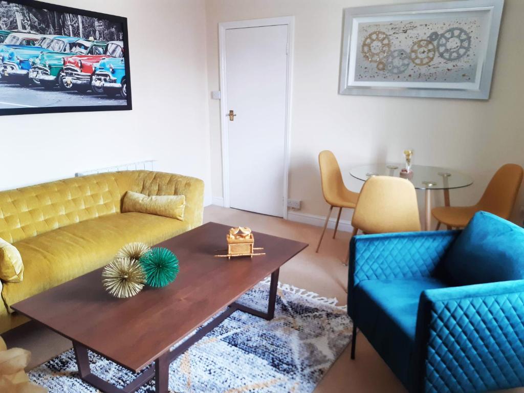 a living room with two couches and a coffee table at Pulteney Road Apartment in Bath