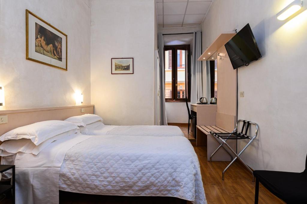 a hotel room with a bed and a flat screen tv at Hotel Julia in Rome