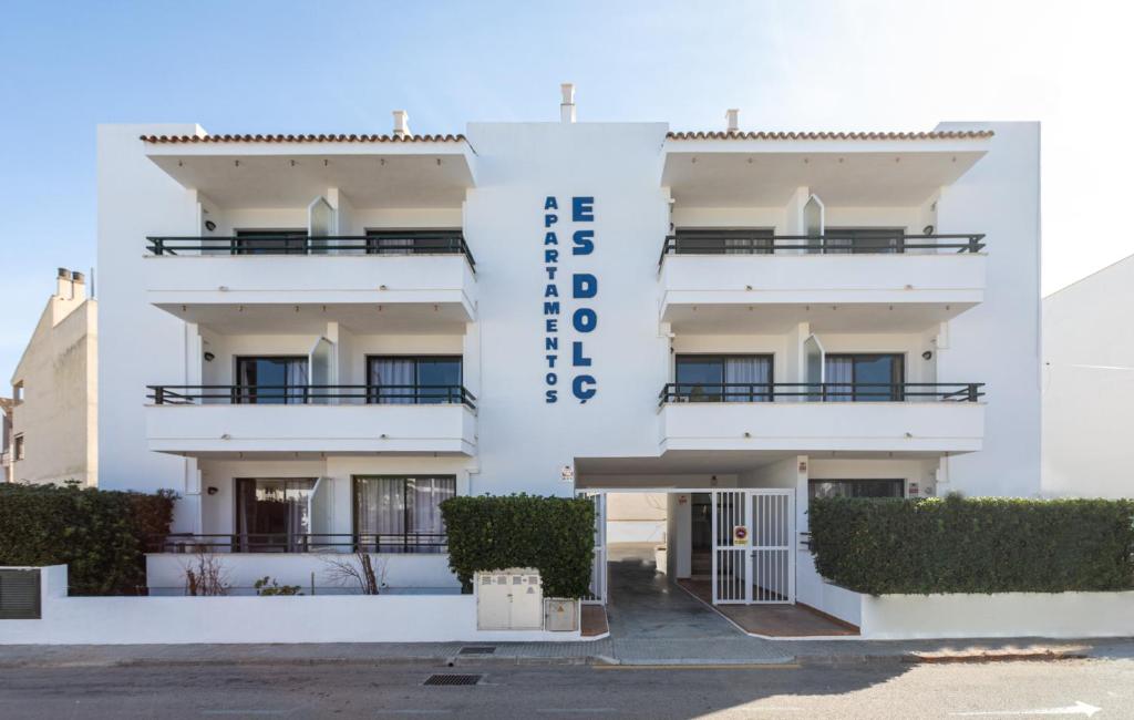 a white building with the word hotel at Apartamentos Es Dolç in Colònia de Sant Jordi