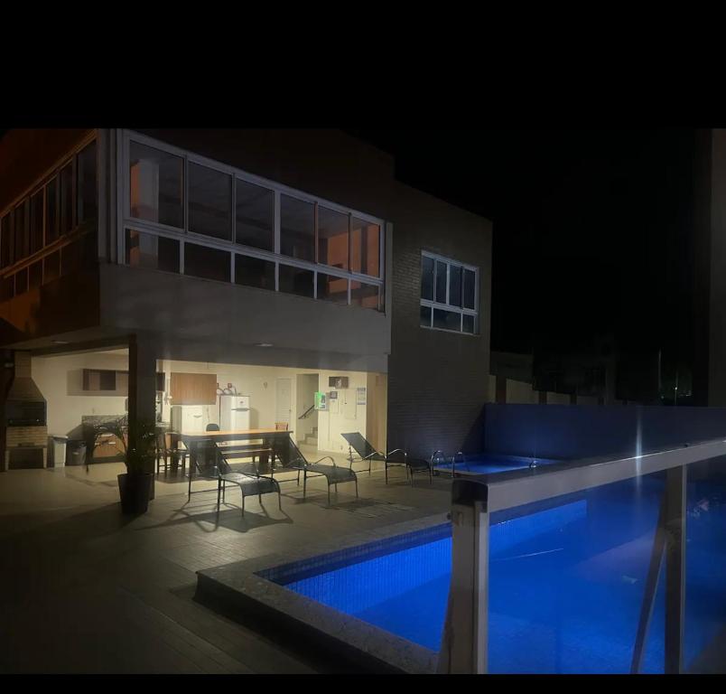 a house with a swimming pool at night at Não está disponível para locação in Ilhéus