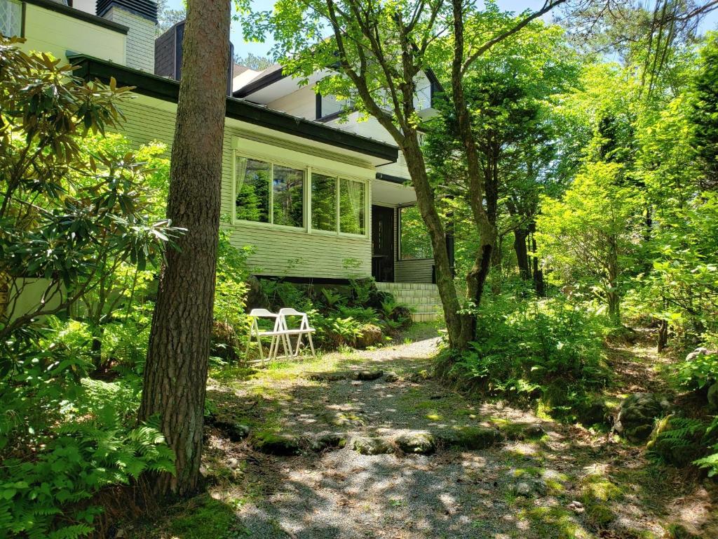 a home with a pathway leading to the front yard at Karuizawa Villa Etoile - Vacation STAY 15095 in Kita-karuizawa