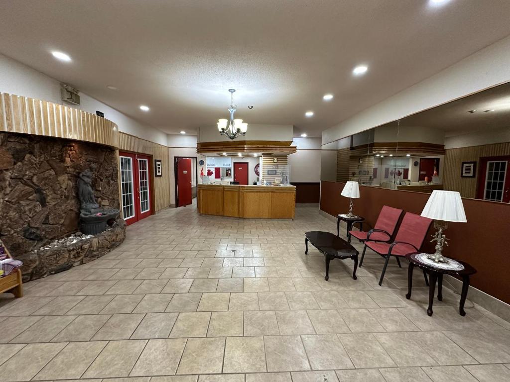 a lobby of a hospital with a stone fireplace at HOTEL CLASSIC COMFORT in Cornwall