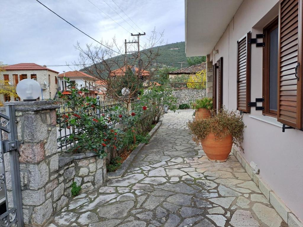 a stone walkway with potted plants and a building at Kontolati's Mountain House in Graviá