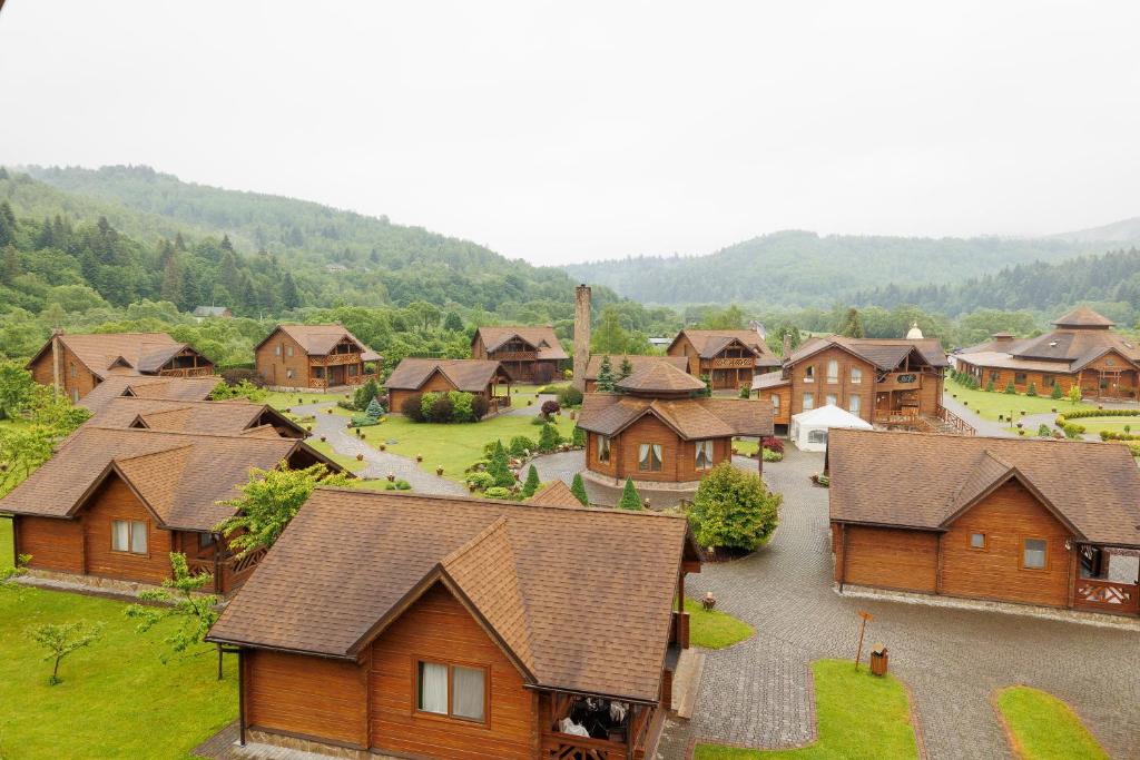 an aerial view of a village with wooden houses at TAOR Karpaty Resort & Spa in Skhidnitsa