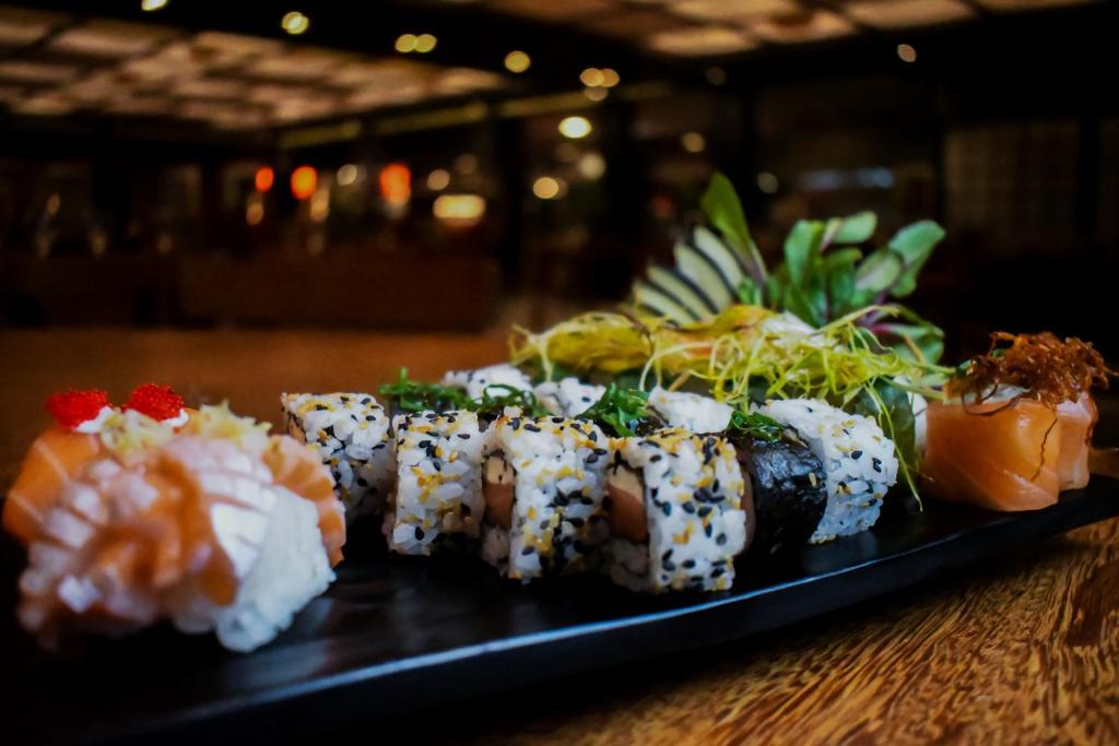 a plate of sushi on top of a table at Costao do Santinho Resort All Inclusive in Florianópolis