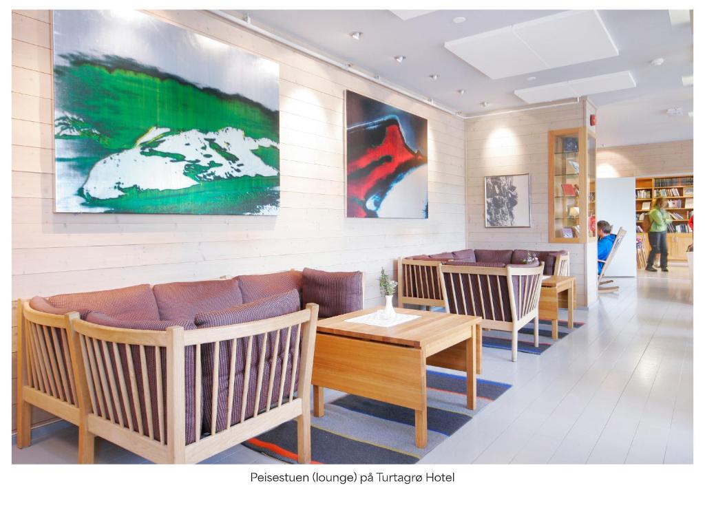 a waiting room with couches and tables in a store at Turtagrø Hotel in Fortun