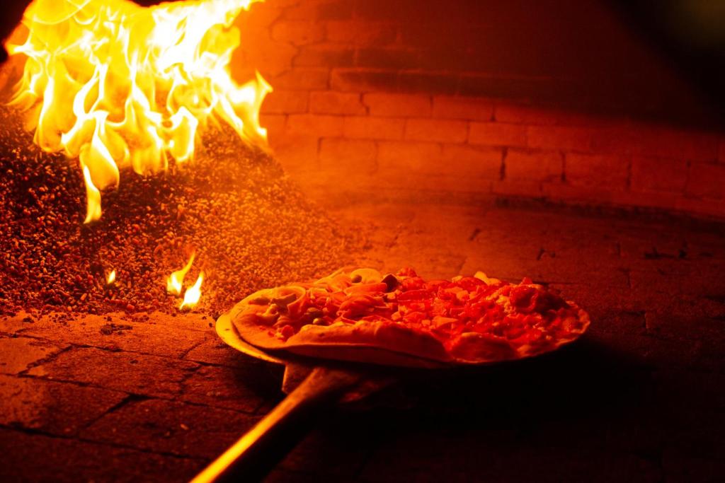a pizza is cooking in a brick oven at Costao do Santinho Resort All Inclusive in Florianópolis