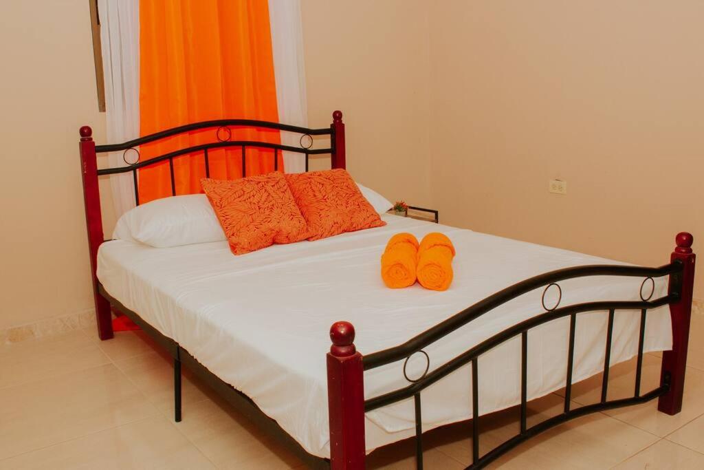 a bedroom with a bed with orange shoes on it at San Juan Loft in Santiago