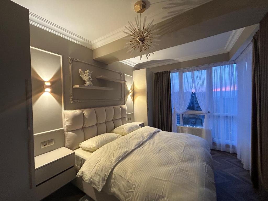 a bedroom with a white bed and a window at GT apartments in Chisinau in Chişinău
