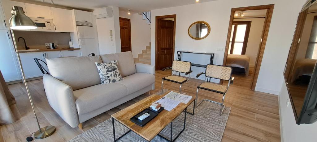 a living room with a couch and a coffee table at Apartamentos Callejón de Recogidas 2 in Toledo