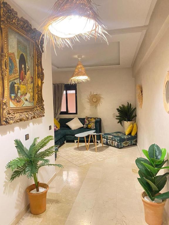a living room with a couch and a painting on the wall at Cosy & magnifique appartement Marrakech in Marrakech