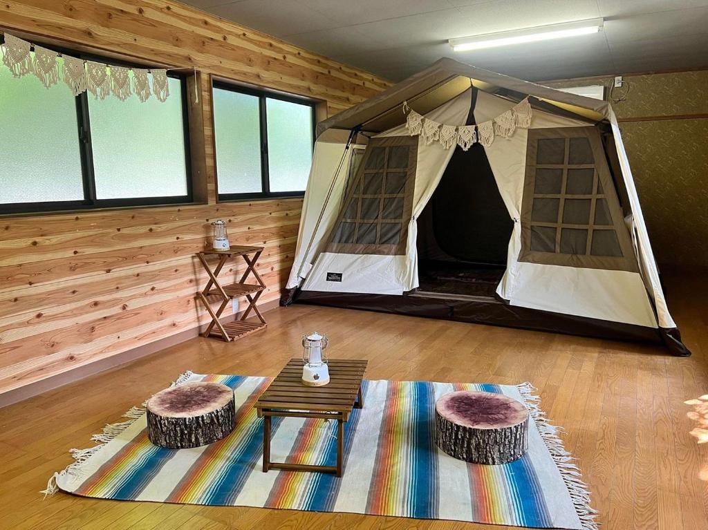 a tent in a room with a table and a rug at Nagatoro Camp Village - Vacation STAY 06872v in Minano