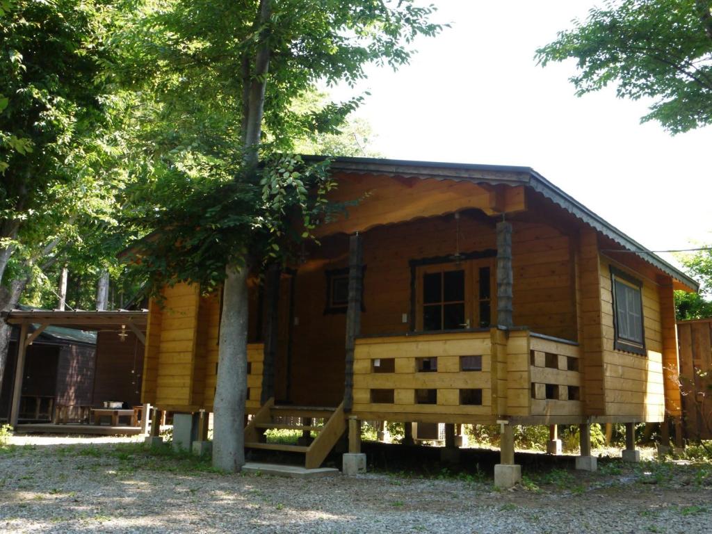 a small log cabin with a tree at Nagatoro Camp Village - Vacation STAY 06873v in Minano