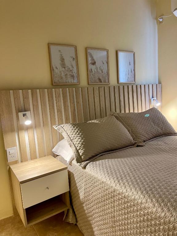 a bedroom with a bed with a wooden headboard at Chill Home IV in Posadas