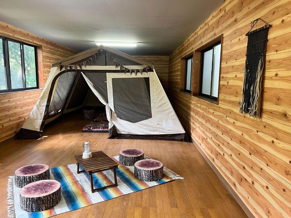 a tent in a room with stools and a table at Nagatoro Camp Village - Vacation STAY 06871v in Minano