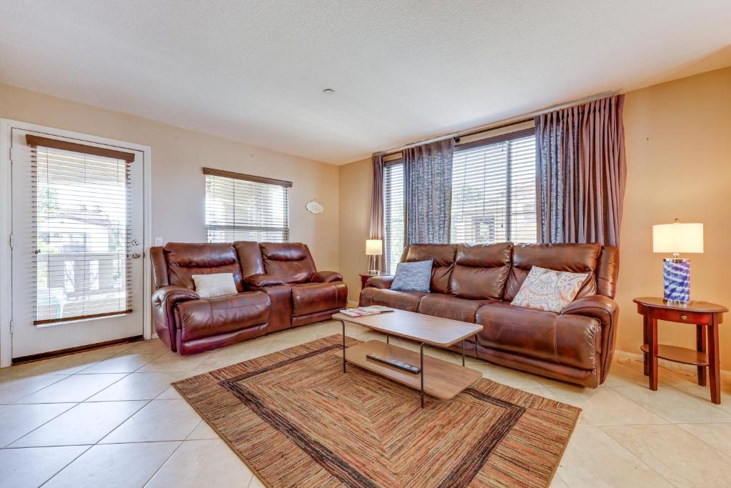 a living room with two leather couches and a table at Oxnard Vacation Rental about 2 Mi to Beach! in Oxnard