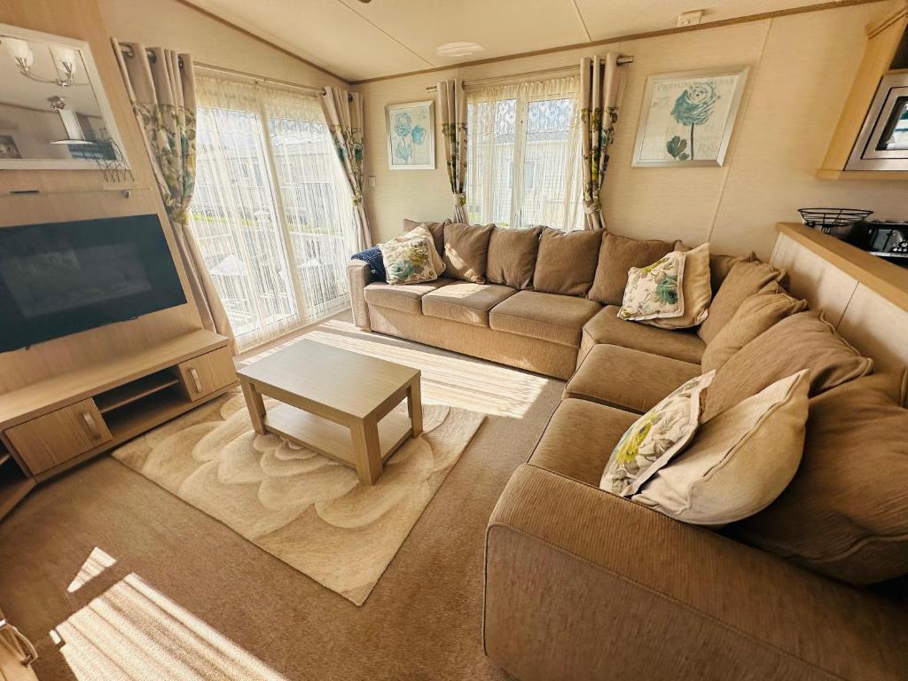 a living room with a couch and a flat screen tv at Golden Sands, Ingoldmells, 6 berth in Ingoldmells