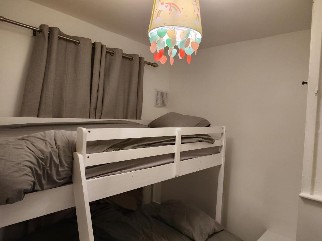 a bedroom with a bunk bed and a chandelier at Garden of peace in Erith