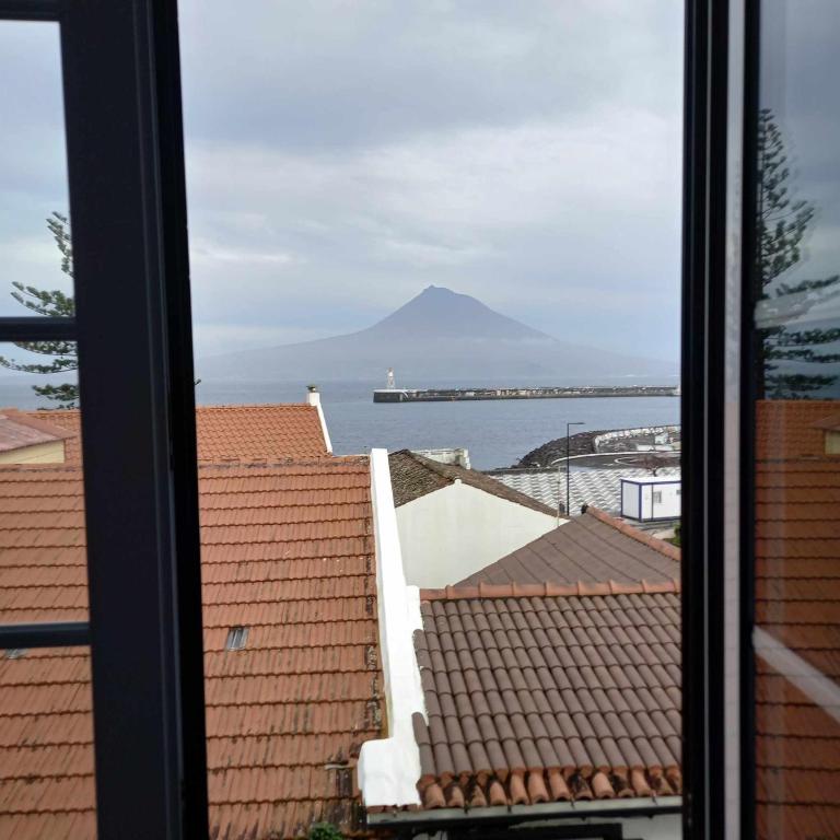 a view of the ocean from a window at Alojamento Quadros in Horta