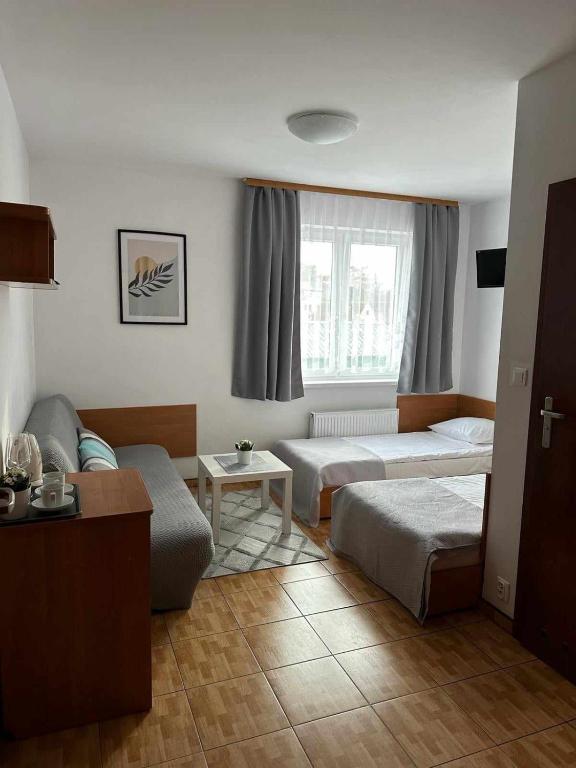 Postel nebo postele na pokoji v ubytování Pensjonat Melodia