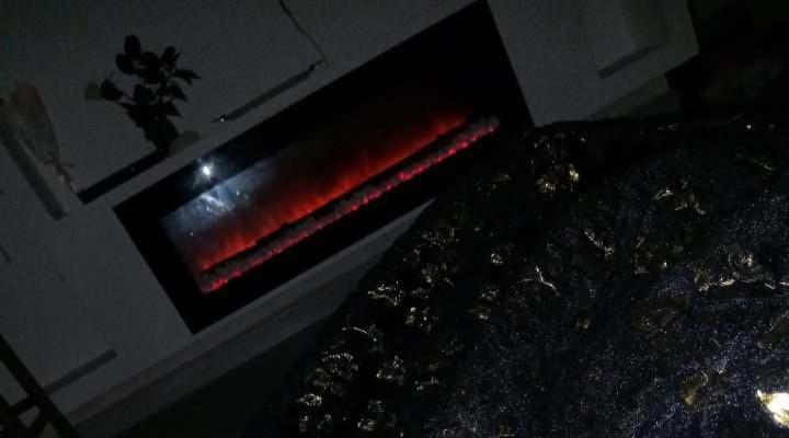a brick oven with a red fire in it at bejaia room in Bejaïa