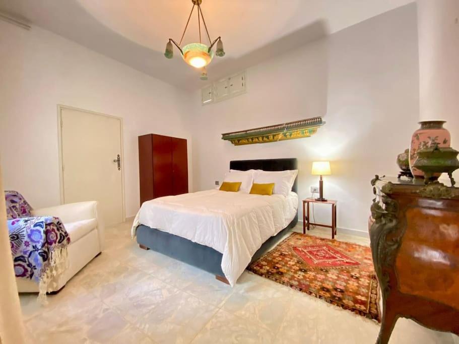 Dar Mimoun BeyにあるSuite Sidi Faouah el Meskのベッドルーム1室(ベッド1台、ソファ、椅子付)