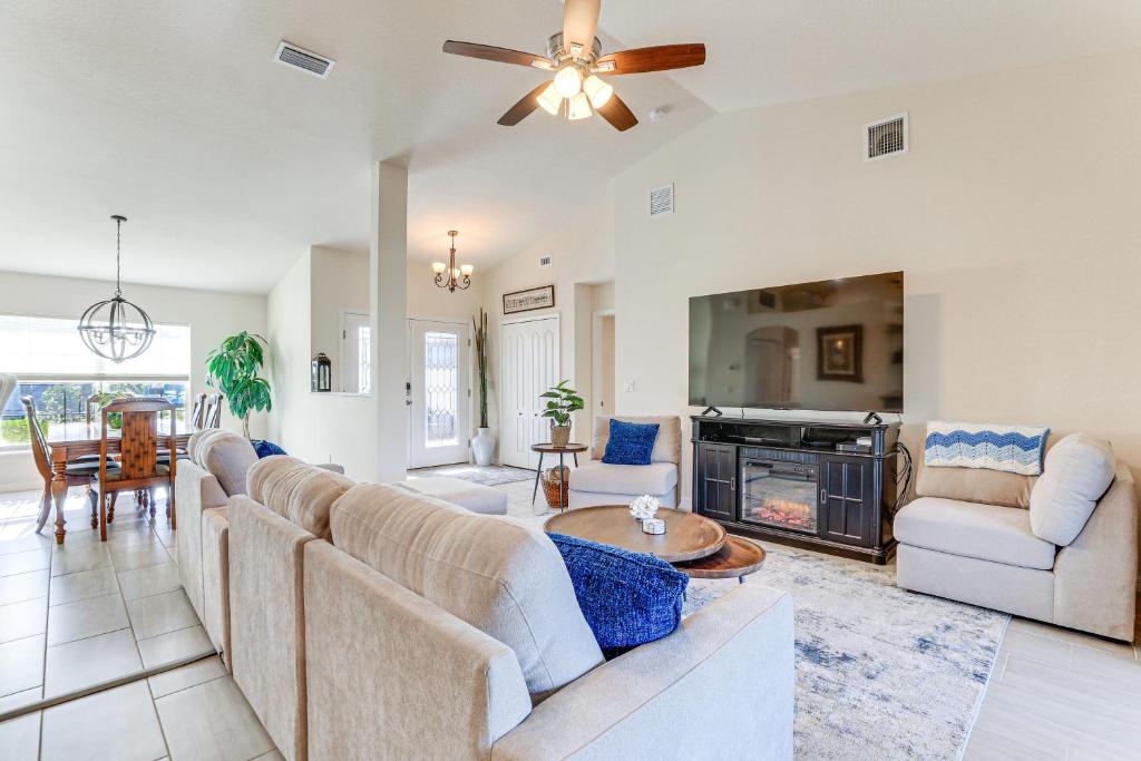 a living room with a couch and a fire place at Beautiful Venice Getaway, 4 Mi to Manasota Beach! in Venice