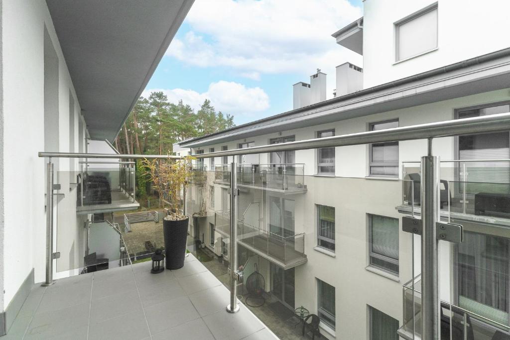 an apartment balcony with a view of a building at Sunset A23 przy plaży in Pobierowo