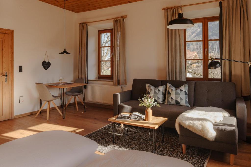 a living room with a couch and a table at Staudingerhof in Staudach-Egerndach